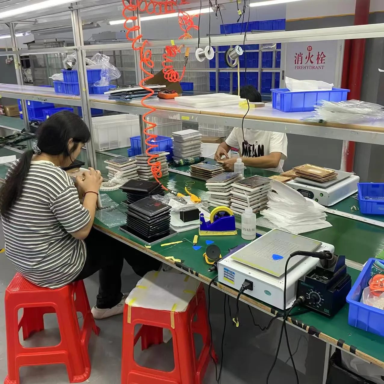 Factory worker operating SMT assembly equipment