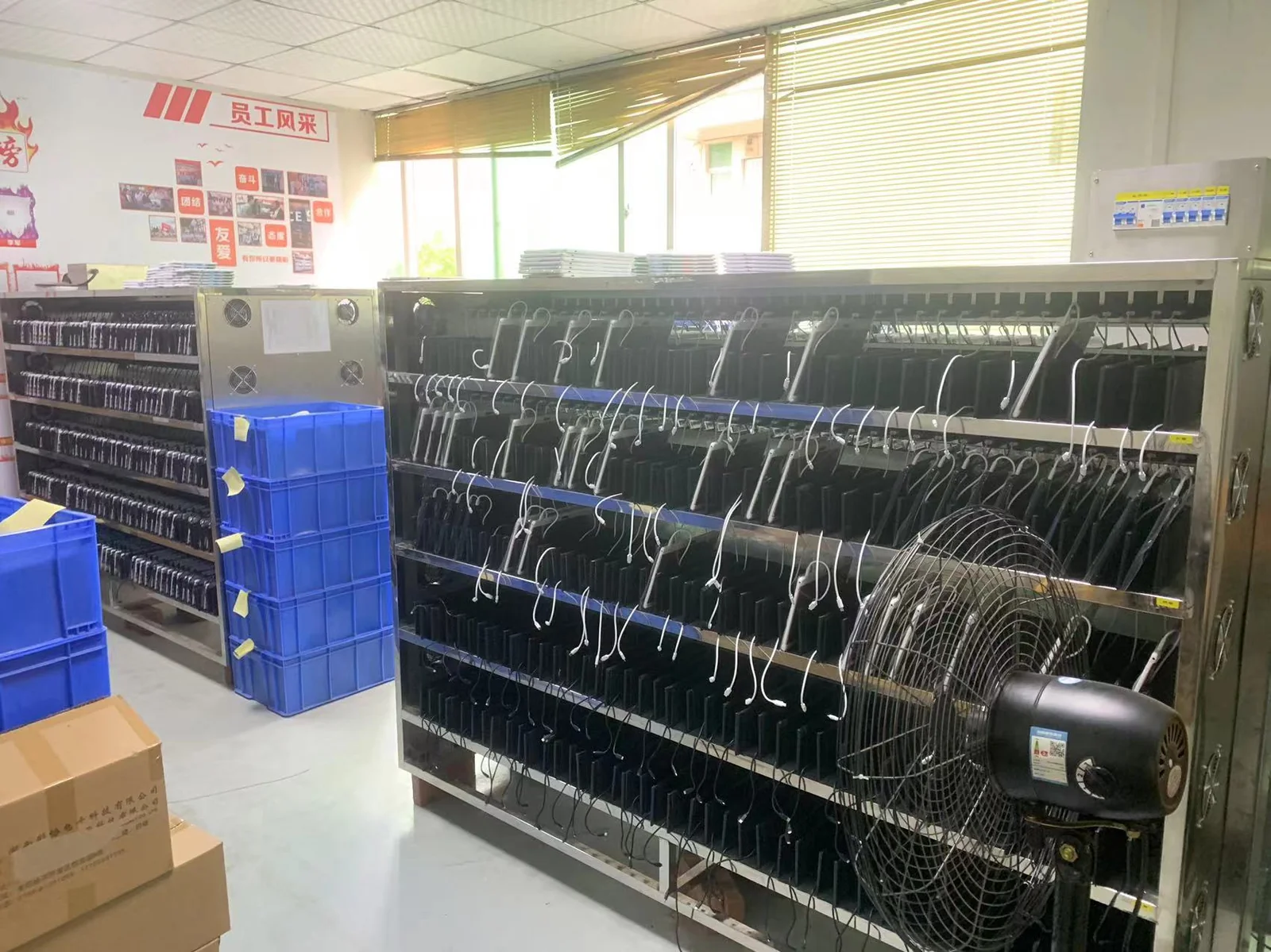 Tablet battery aging test racks at Wintouch QA lab