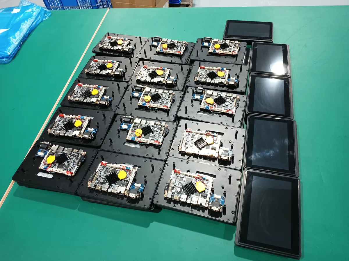 Tablet mainboards and screen modules laid out for functional testing — Wintouch